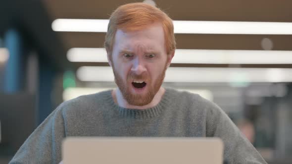 Portrait of Man Reacting to Loss on Laptop alt