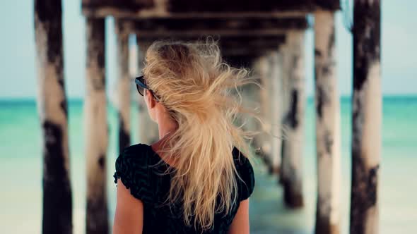 Tanned Woman Relaxing On Beach. Woman Having Fun On Zanzibar Tanzania. Travel Mood Wind Blows Dress. alt