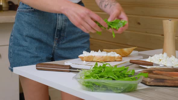 Putting Rucola In Sandwich With Ricotta
