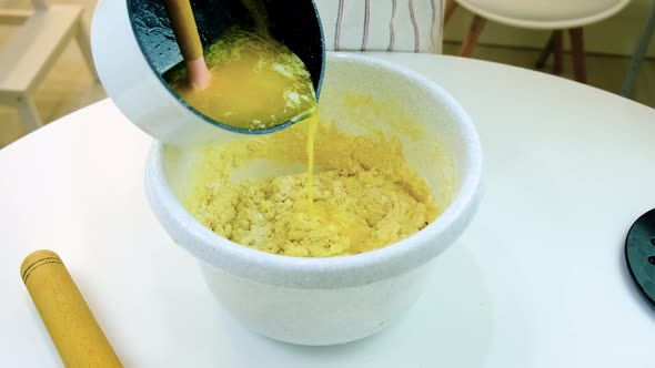 A Woman is Kneading Dough in the Kitchen alt