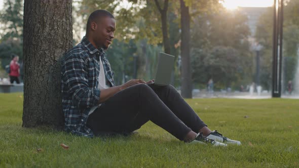 Young African American Man Guy Student Male Freelancer Worker User with Laptop Working Typing alt