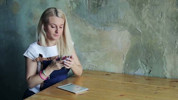 Woman In a Stylish Room With Tablet And Phone