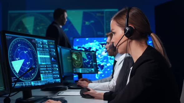 Workplace of the air traffic controllers in the control tower. Team of professional officers. alt