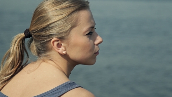 Girl Sitting By The Water And Looking