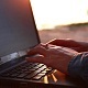 Woman Talks on a Laptop on the Beach - VideoHive Item for Sale