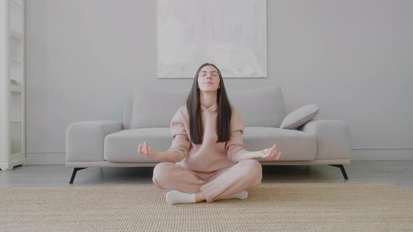 Young Caucasian woman sitting in lotus position and resting and relaxing.
