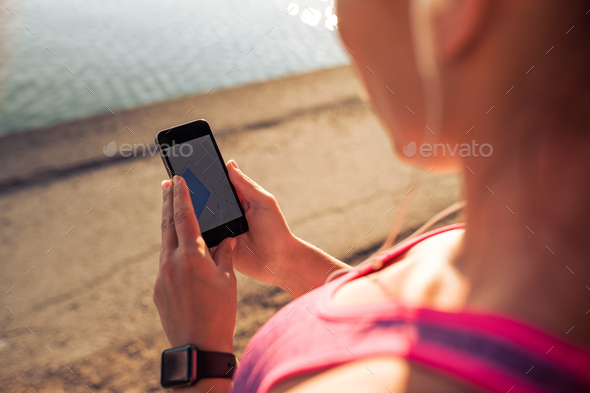Sports woman using smart phone - Stock Photo - Images