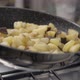 Potatoes and meat cooking slowmotion 