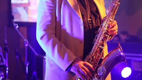 The Man In The White Suit Playing The Saxophone