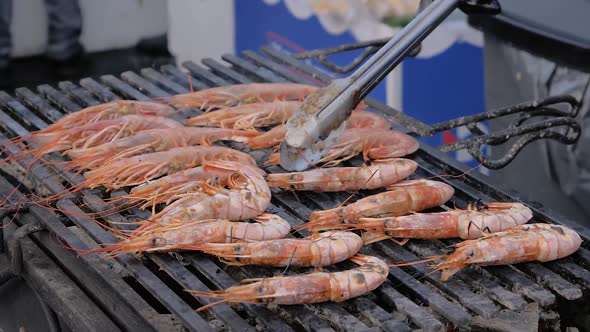 Slow Motion: Chef Grilling Fresh Red King Prawns on Brazier
