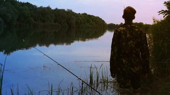 Fisherman Stands on the Riverside. alt