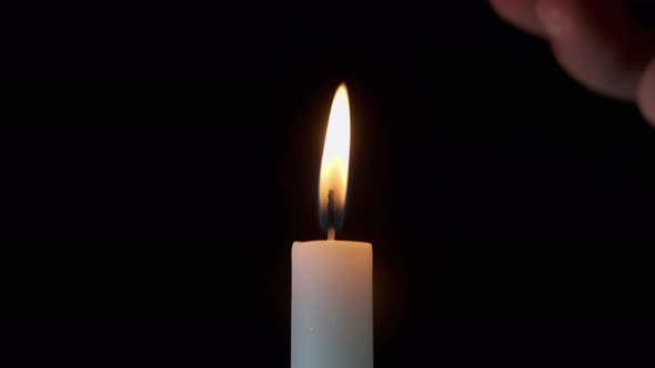 Footage of Using a Match Light a Candle on on a Dark Background alt