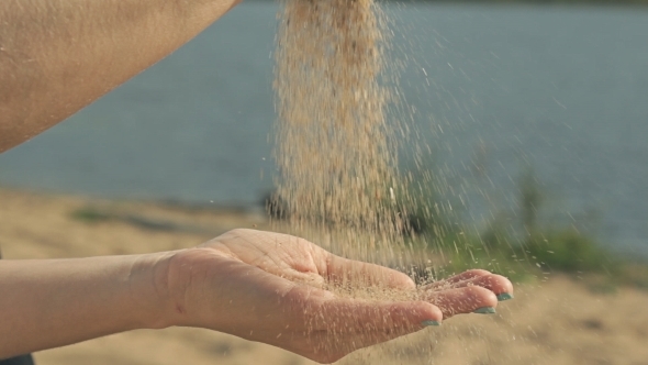 Girl Pours Sand Into The Hands Of