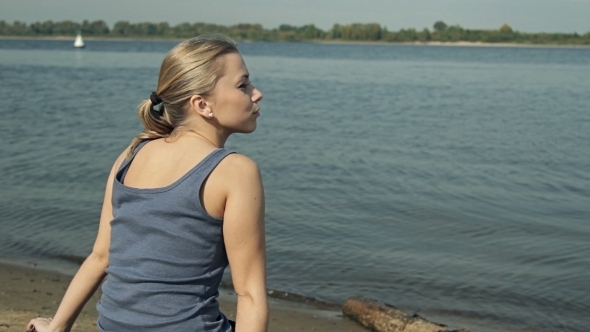 Girl Sitting By The Water