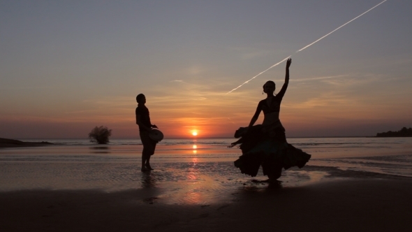 Silhouette Girl Dancing Exotic Dance With Drummer