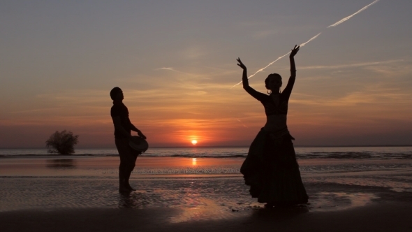 Silhouette Girl Dancing Exotic Dance With Drummer