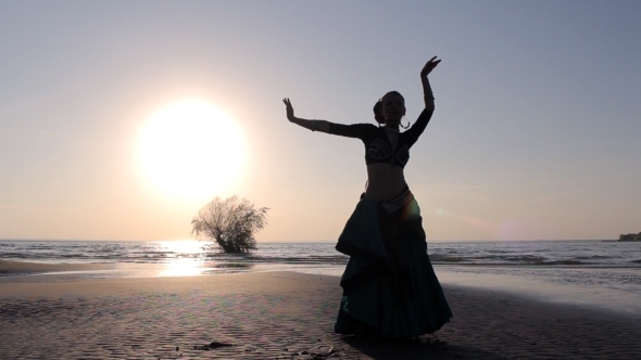 Silhouette Girl Dancing Exotic Dance On Beach