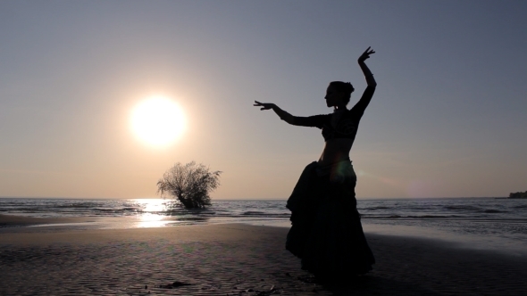 Silhouette Girl Dancing Exotic Dance On Beach