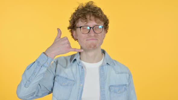 Call Me Gesture By Redhead Young Man, Yellow Background alt