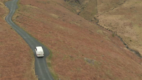 Mini van on road in Lake District National Park, Cumbria, UK