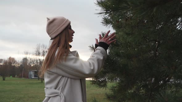Girl is Touching the Fir Branches alt