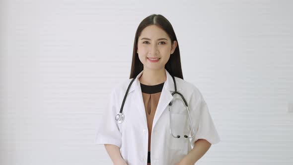 Portrait, a beautiful Asian female doctor standing smiling