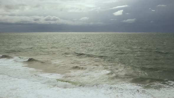 Gray Sky with White Clouds and Post-storm Sea