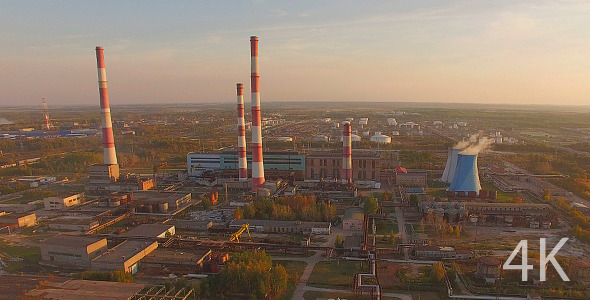 Huge Industrial Plant with Pipes at Sunset  alt