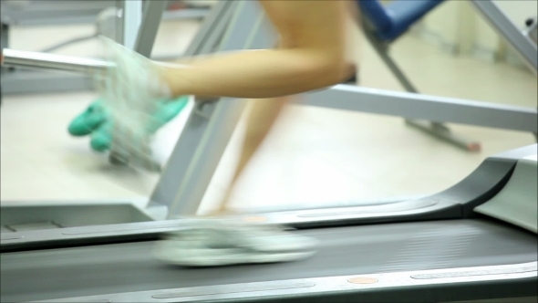 Young Woman Running On a Treadmill