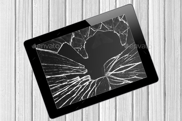Black Touch Screen Tablet with broken screen over wooden backgro