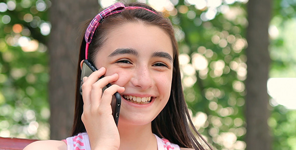 Teenager Girl Talking on Smartphone alt
