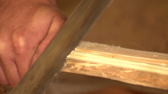 Carpenter Cleans Wood Plane