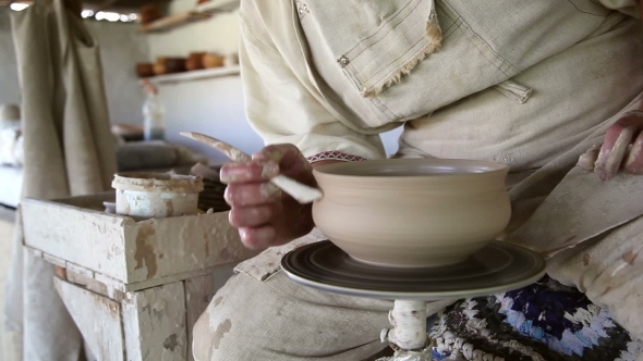 Potter Sculpts Clay Small Pot