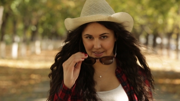 Girl Walks In Autumn Alley To The Camera And Takes