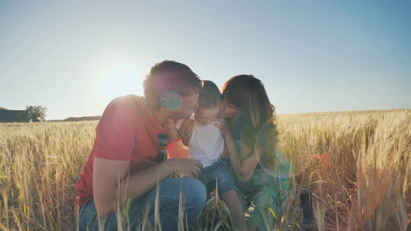 Happy Family Having Fun and Laughing on a Spring Summer Day at Sunset alt