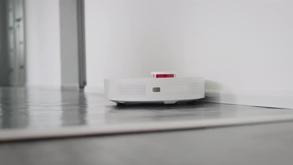 Robot Vacuum Cleaner Cleans a Modern Apartment alt