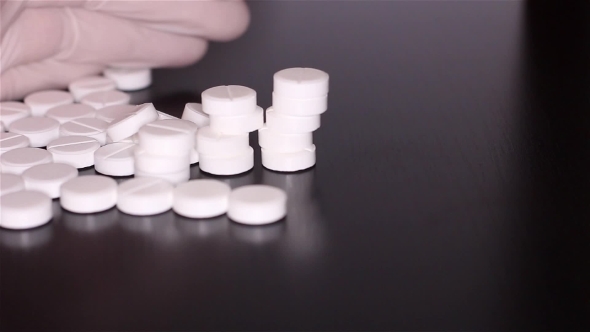 White Pills Scattered On The Table