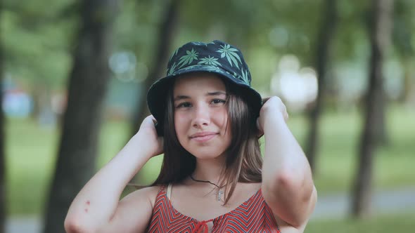 Portrait of a Teenage Girl in a Panama Hat in a Park in the Summer alt