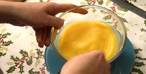 Woman Whisking Eggs in a Glass Bowl 