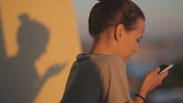 Young Woman With Sun Shadow Silhouette Use Smart