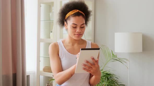 African american woman pensively thinks and making notes in paper notebook. Writing idea alt