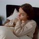 Upset Lovely Young Female with Birth Hands Anomaly Hugging Pillow at Home - VideoHive Item for Sale