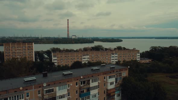 An Aerial Shot of a Small Town with a Power Plant and Old Houses