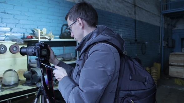 Young Male Photographer Making a Photo For Stocks