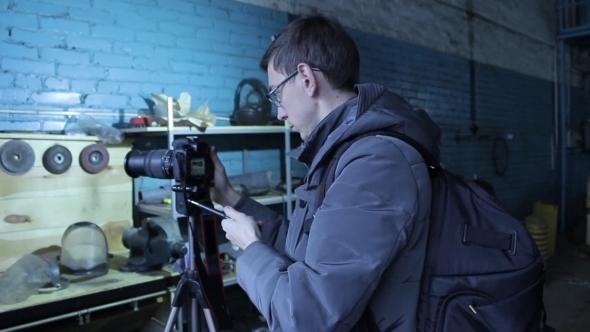 Young Male Photographer Making a Photo For Stocks