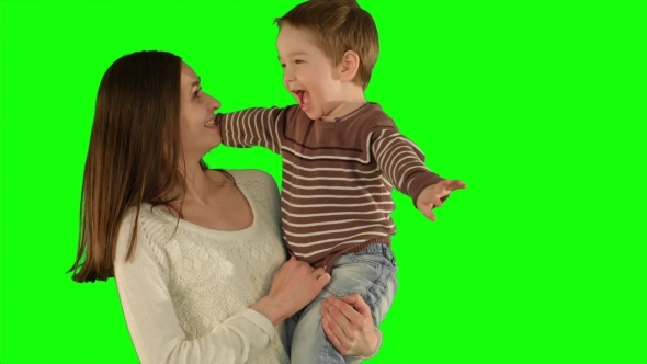 Happy Family Having Fun On a Green Screen alt