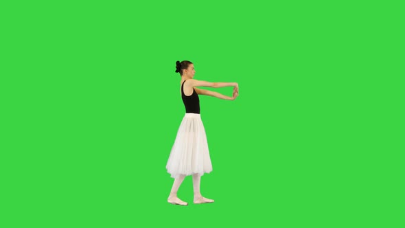 Young Ballerina Walks Warming Up Her Joints on a Green Screen Chroma Key