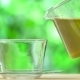 Steaming Cup Of Tea And Teapot On Blur Background - VideoHive Item for Sale