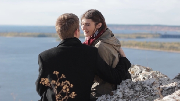 Couple In The Mountains Enjoying Life And Kissing