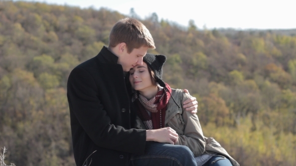 Couple In The Mountains Enjoying Life And Kissing